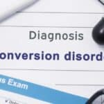 conversion disorder diagnosis written on paper