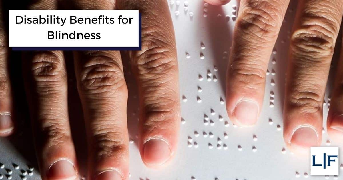 disability benefits for blindness on top of hands reading braille